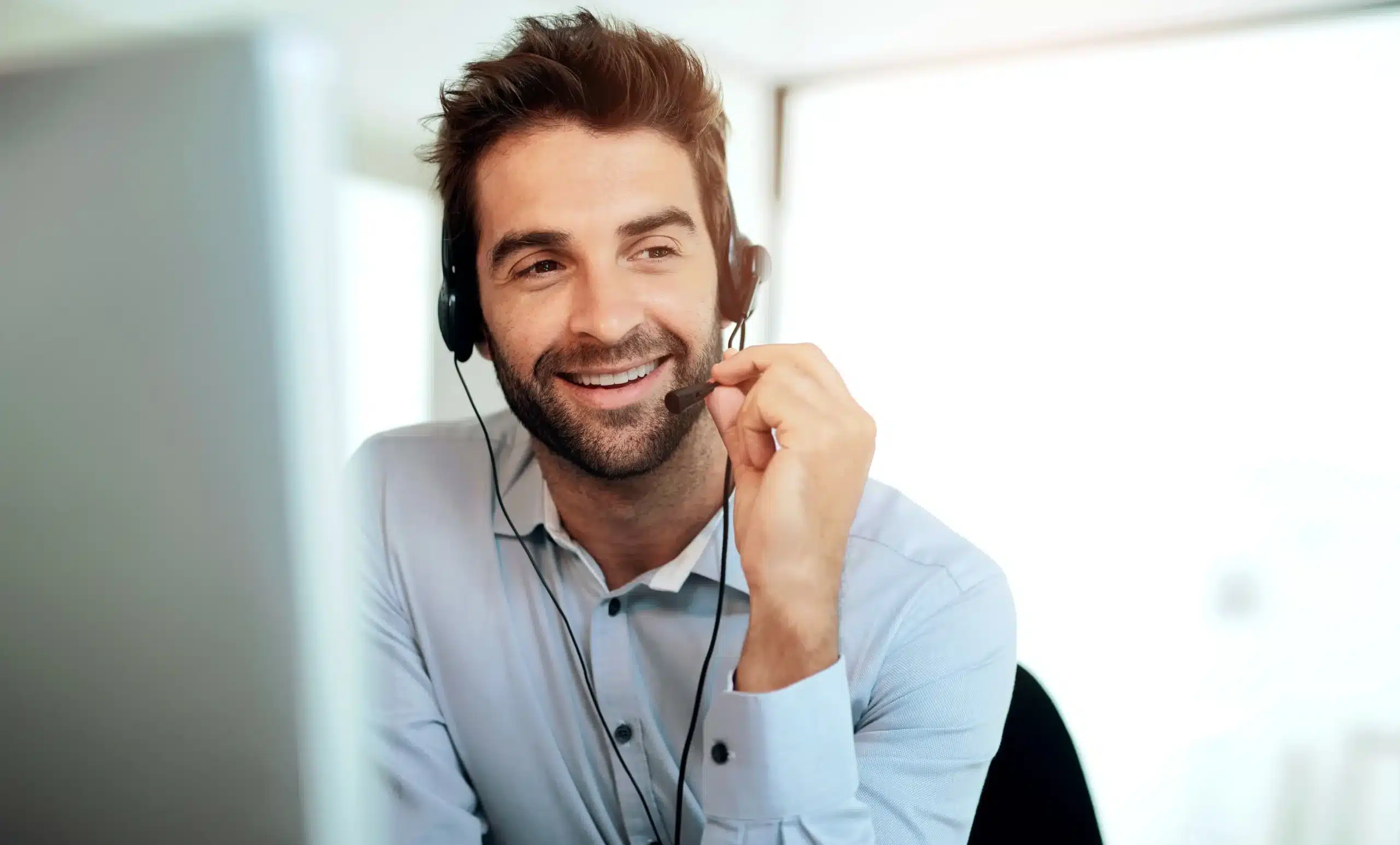 man smiling with headset