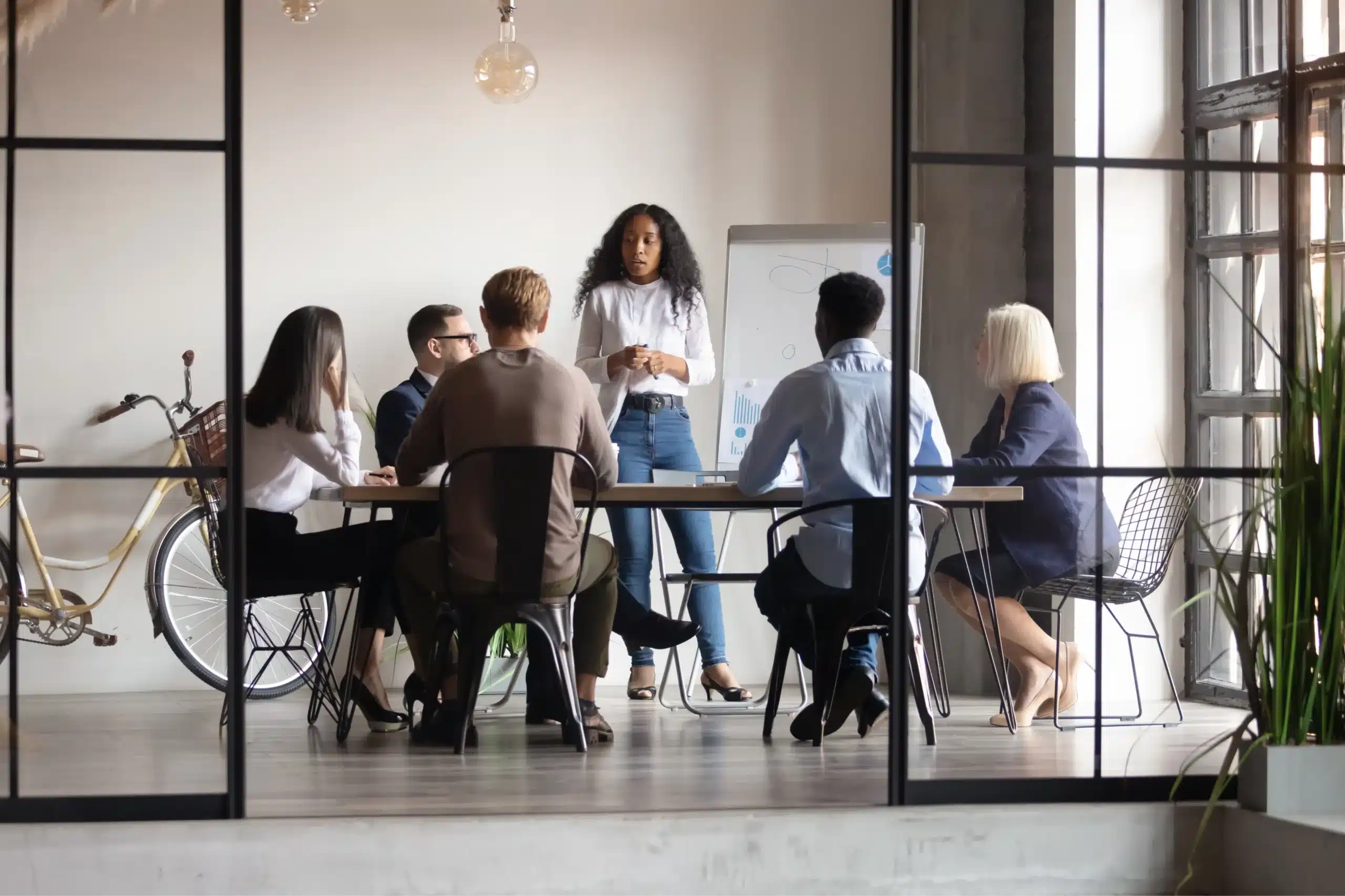 Women presenting to a group in front of a white board